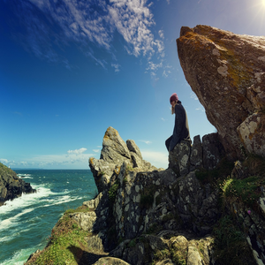 Image by jplenio titled ’woman, sea, cliffs’. Source: Pixabay